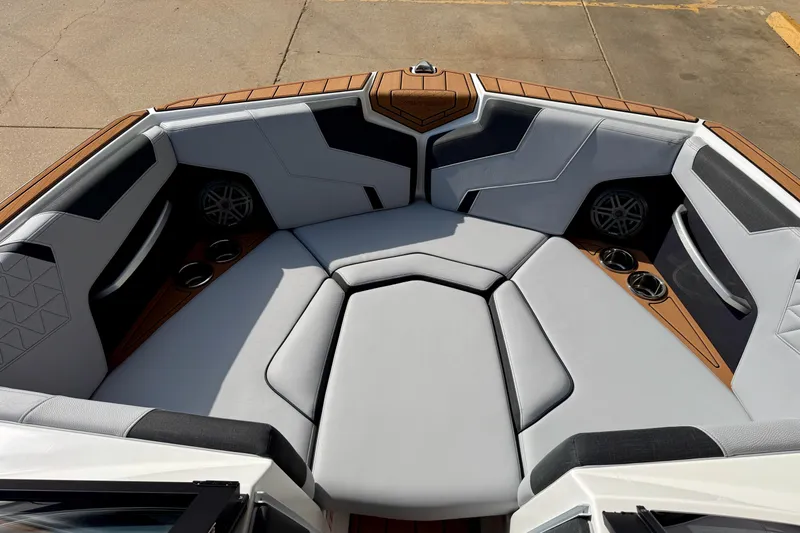 Slide: The Image of 2026 Nautique Super Air Nautique GS20 boat interior with cushioned seating and cup holders. - 21