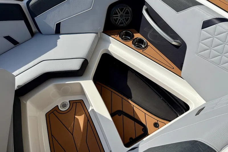 Slide: The Image of 2026 Nautique Super Air Nautique GS20 interior with seating, cup holders, and storage compartment. - 22