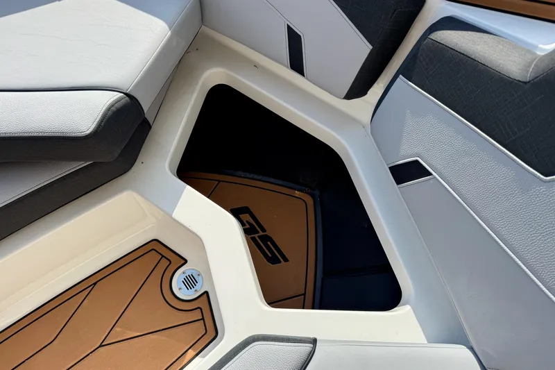 Slide: The Image of 2026 Nautique Super Air Nautique GS20 interior seating and storage compartment. - 23