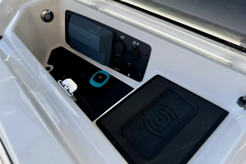 Slide: The Image of 2026 Nautique Super Air Nautique GS20 dashboard with controls and wireless charging pad. - 26