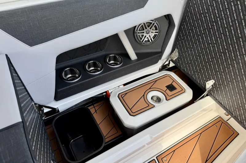 Slide: The Image of 2026 Nautique Super Air Nautique GS20 interior with cup holders, speaker, and storage compartment. - 31