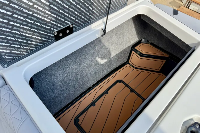 Slide: The Image of 2026 Nautique Super Air Nautique GS20 storage compartment with custom flooring. - 33