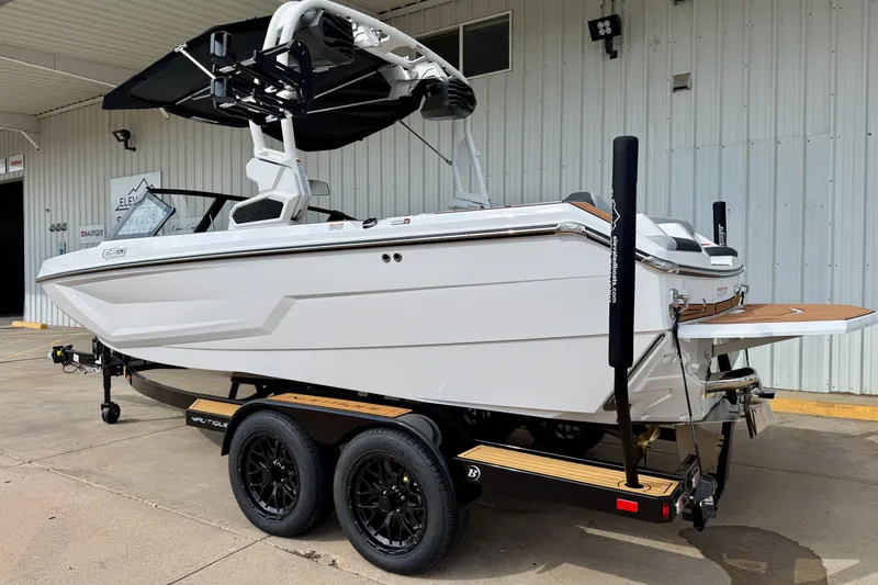 Slide: The Image of 2026 Nautique Super Air Nautique GS20 boat on trailer, parked outside a building. - 4