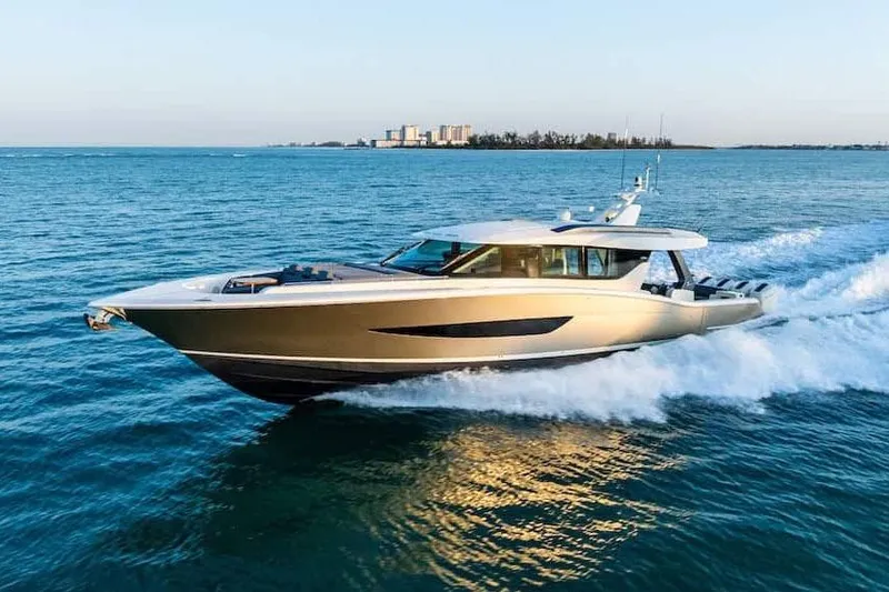 Slide: The Image of Manufacturer Provided Image: 2026 Scout 670 LXS yacht cruising on open water, city skyline in background. - 0