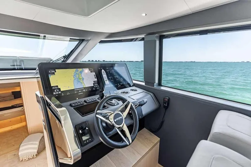 Slide: The Image of Manufacturer Provided Image: Interior of 2026 Scout 670 LXS boat with advanced navigation system and ocean view. - 11