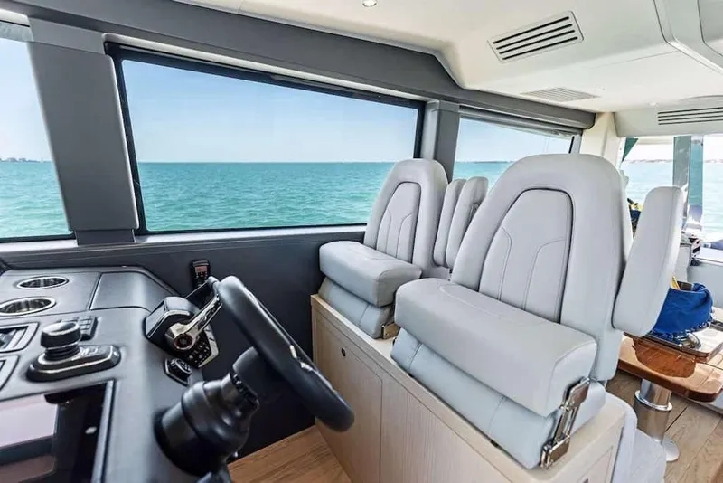 Slide: The Image of Manufacturer Provided Image: Interior of 2026 Scout 670 LXS boat with modern seating and ocean view. - 12