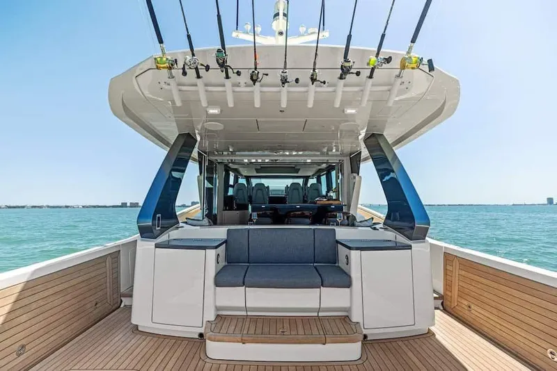 Slide: The Image of Manufacturer Provided Image: 2026 Scout 670 LXS luxury boat interior with fishing rods, ocean view, and seating area. - 14