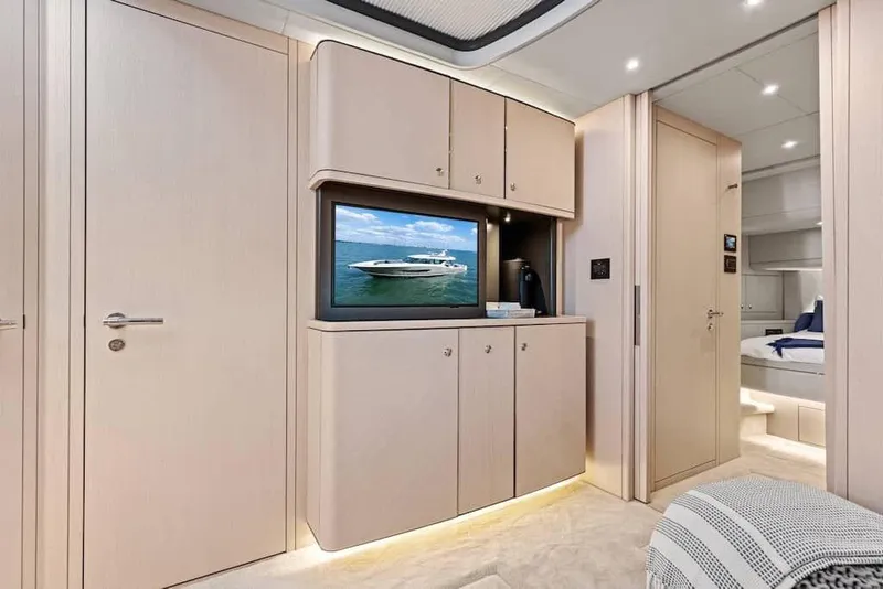 Slide: The Image of Manufacturer Provided Image: Luxurious interior of 2026 Scout 670 LXS yacht with modern cabinetry and TV. - 19