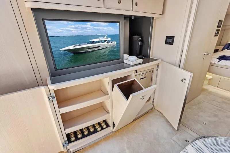Slide: The Image of Manufacturer Provided Image: Luxurious interior of 2026 Scout 670 LXS yacht with TV and storage cabinets. - 20