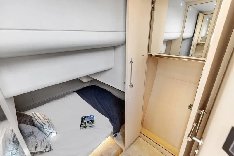 Slide: The Image of Manufacturer Provided Image: 2026 Scout 670 LXS cabin interior with bed, pillows, and closet space. - 23