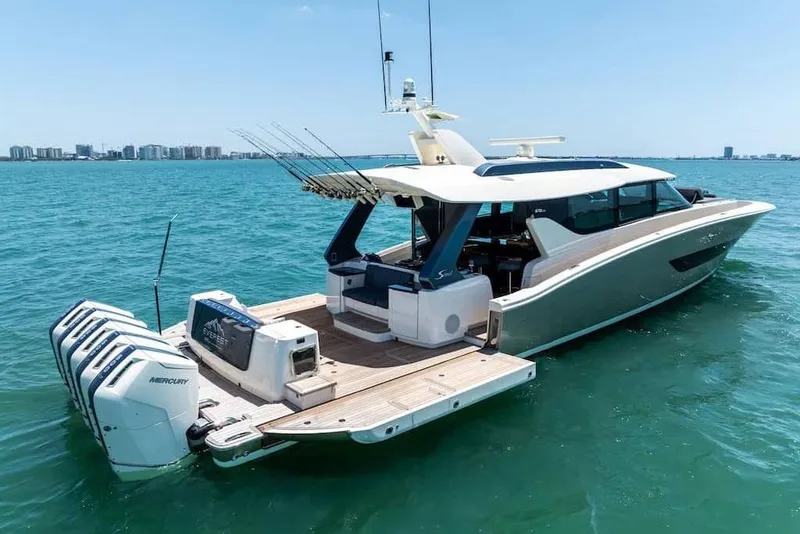 Slide: The Image of Manufacturer Provided Image: Luxury 2026 Scout 670 LXS yacht on clear blue water, featuring multiple outboard engines. - 4