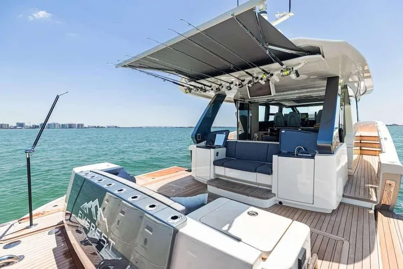 Slide: The Image of Manufacturer Provided Image: 2026 Scout 670 LXS luxury boat with fishing rods, spacious deck, and ocean view. - 8