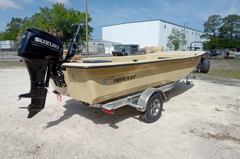Slide: The Image of 2025 Fibercraft F17 boat with Suzuki outboard motor on a trailer. - 12