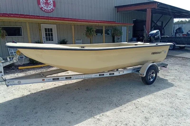 Slide: The Image of 2025 Fibercraft F17 boat on trailer outside a building. - 3