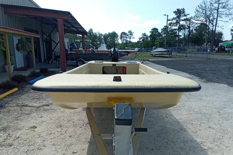 Slide: The Image of Fibercraft F17 boat, 2025 model, parked outdoors near a metal building. - 4