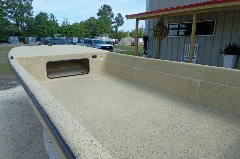 Slide: The Image of 2025 Fibercraft F17 boat with spacious deck, parked outdoors near a building. - 6