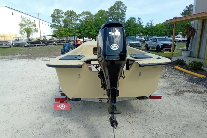 Slide: The Image of 2025 Fibercraft F17 boat with 50HP outboard motor, parked outdoors. - 8