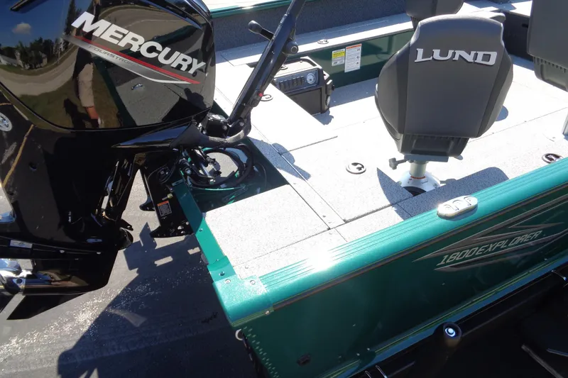 Slide: The Image of 2026 Lund 1800 Explorer Tiller boat with Mercury engine, featuring comfortable seating and sleek design. - 17