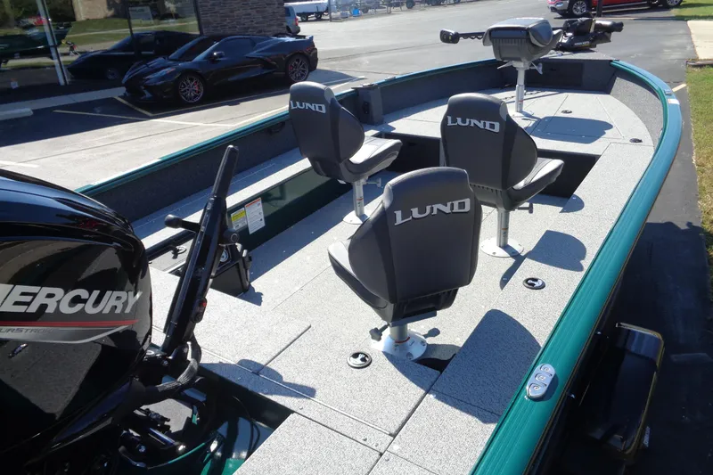 Slide: The Image of 2026 Lund 1800 Explorer Tiller boat with Mercury engine and three seats. - 5