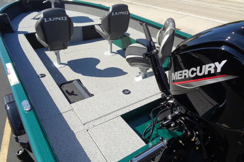 Slide: The Image of 2026 Lund 1800 Explorer Tiller boat with Mercury engine, featuring spacious seating and deck. - 7