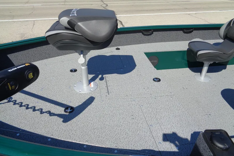 Slide: The Image of 2026 Lund 1800 Explorer Tiller boat interior with seating and trolling motor. - 9