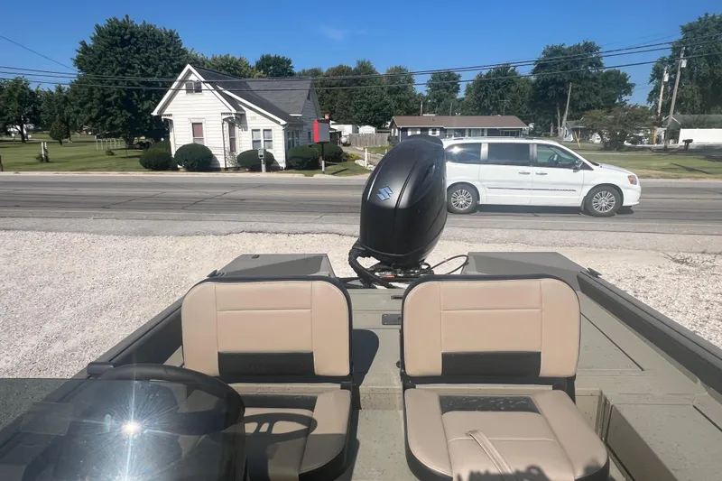 Slide: The Image of 2026 SeaArk V-Cat 200 SC boat, parked outdoors, showcasing spacious deck and seating. - 10