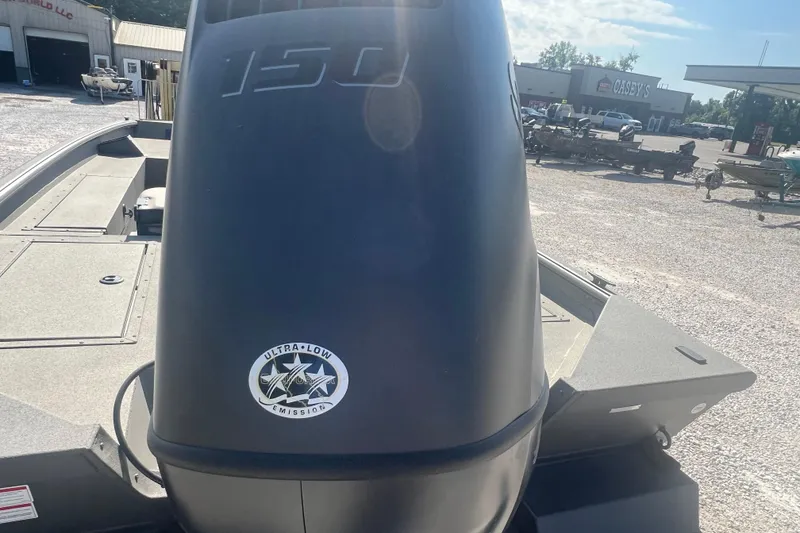 Slide: The Image of 2026 SeaArk V-Cat 200 SC boat with ultra-low emission engine, parked outdoors. - 15