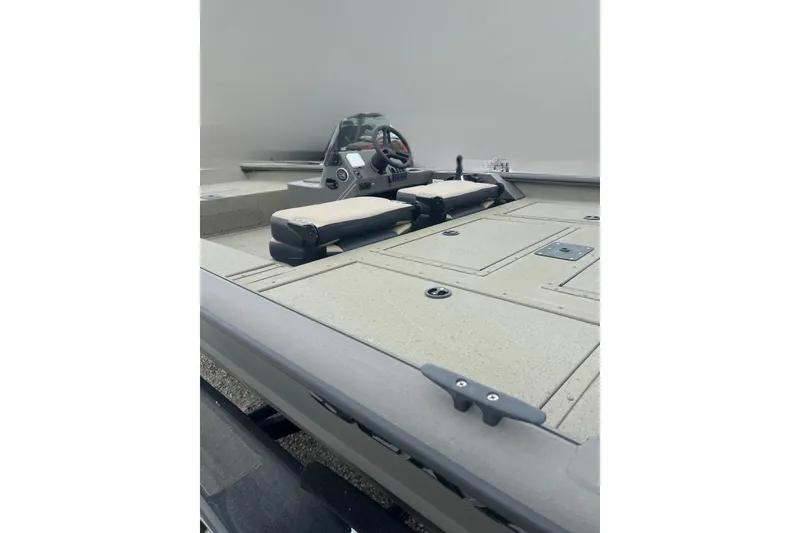 Slide: The Image of 2026 SeaArk Phantom 20XV boat interior with steering console and seating. - 16