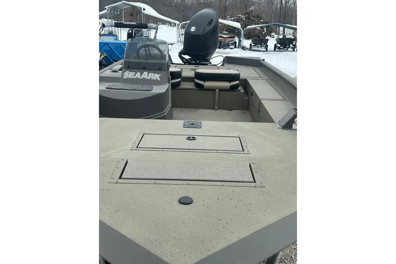 Slide: The Image of 2026 SeaArk Phantom 20XV boat with Suzuki outboard motor, parked in snowy setting. - 19