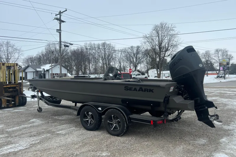 Slide: The Image of 2026 SeaArk Phantom 20XV boat on trailer, parked outdoors in snowy setting. - 20