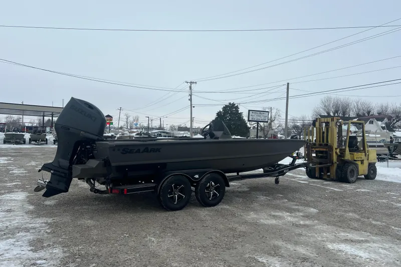 Slide: The Image of 2026 SeaArk Phantom 20XV boat on trailer, parked in snowy lot with forklift nearby. - 22