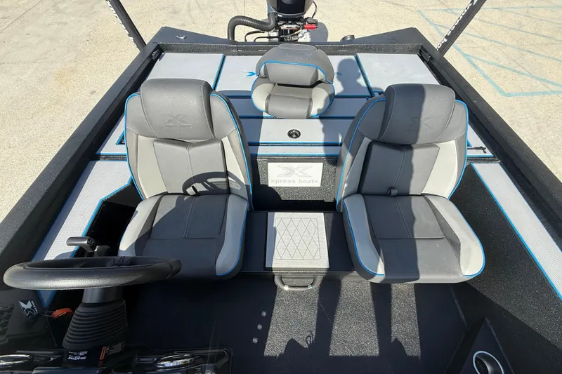 Slide: The Image of 2025 Xpress H20 Bass boat interior with dual seats and steering wheel. - 10