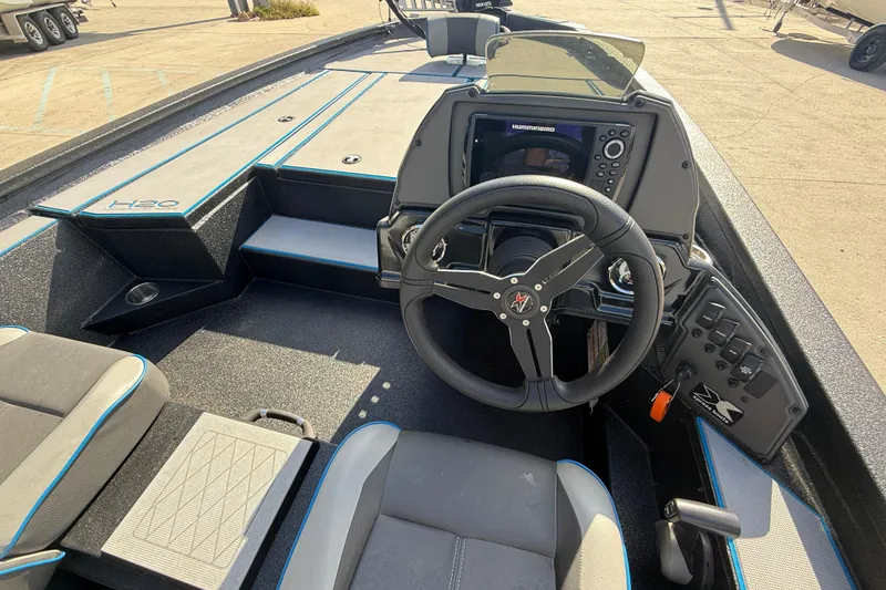 Slide: The Image of 2025 Xpress H20 Bass boat cockpit with steering wheel and control panel. - 11