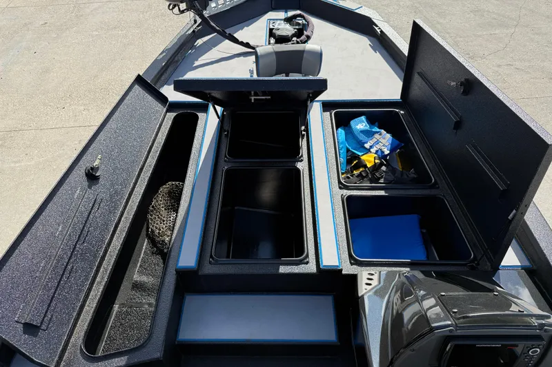 Slide: The Image of 2025 Xpress H20 Bass boat storage compartments with fishing gear and accessories. - 14
