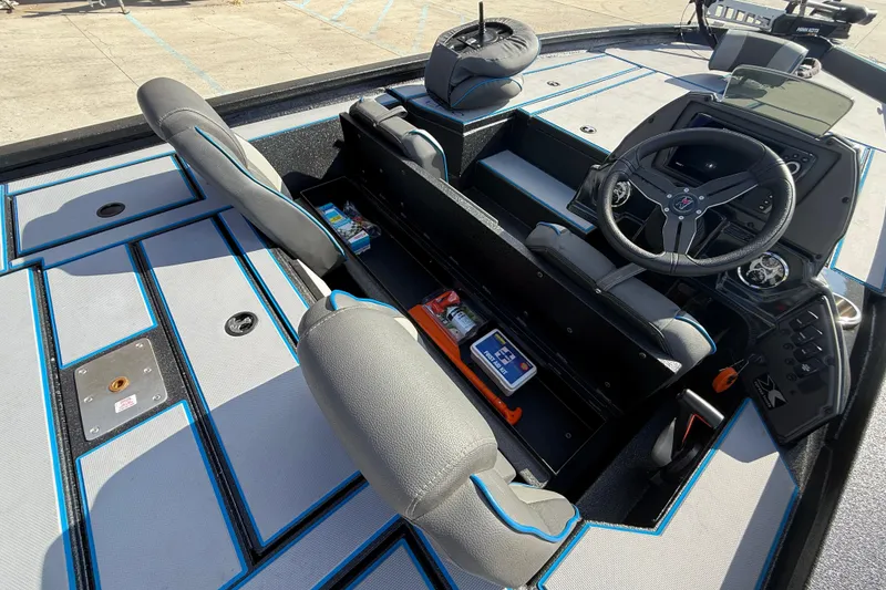 Slide: The Image of 2025 Xpress H20 Bass boat interior with steering wheel, storage compartments, and seating. - 15