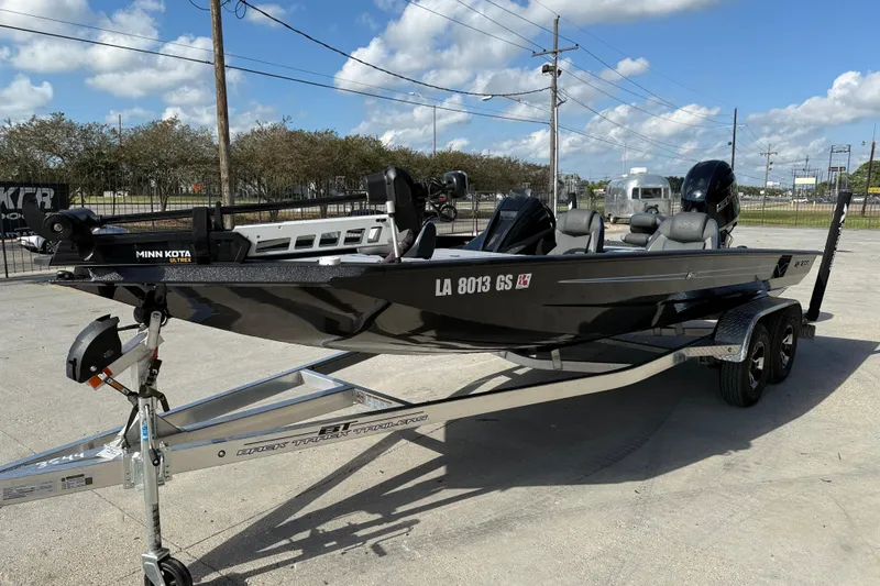 Slide: The Image of 2025 Xpress H20 Bass boat on trailer, featuring Minn Kota Ultrex motor, parked outdoors. - 3