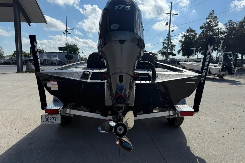 Slide: The Image of 2025 Xpress H20 Bass boat rear view with powerful outboard motor. - 5