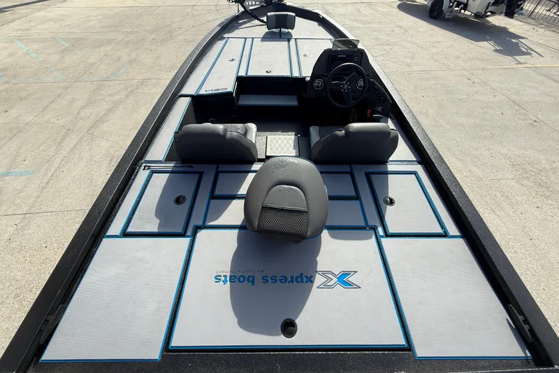 Slide: The Image of 2025 Xpress H20 Bass boat interior with seating and steering console. - 7