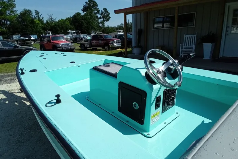 Slide: The Image of 2025 Cast & Blast 17CC Flats boat with turquoise deck and steering console. - 12