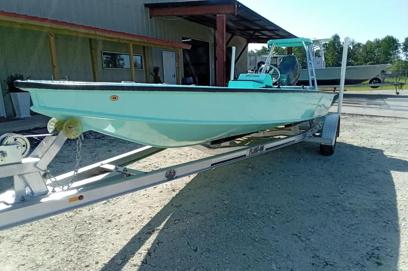 Slide: The Image of 2025 Cast & Blast 17CC Flats boat on trailer, parked outdoors. - 4