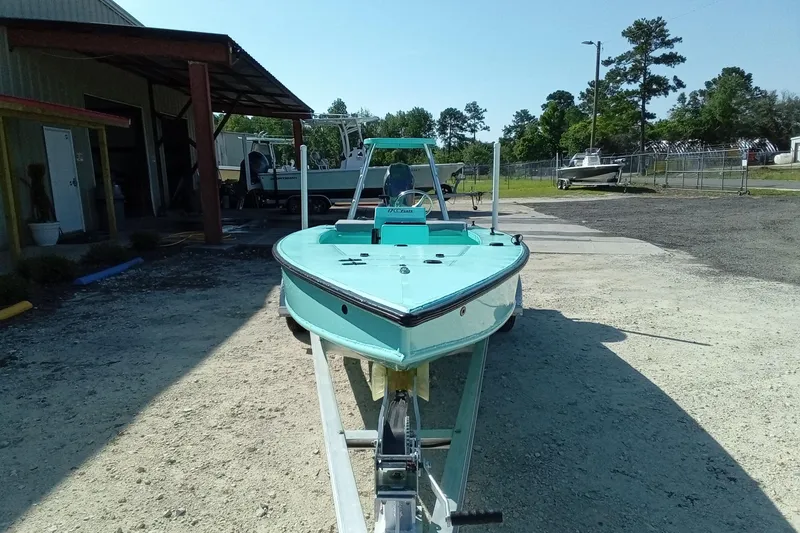 Slide: The Image of 2025 Cast & Blast 17CC Flats boat on trailer, parked outdoors near a building. - 5