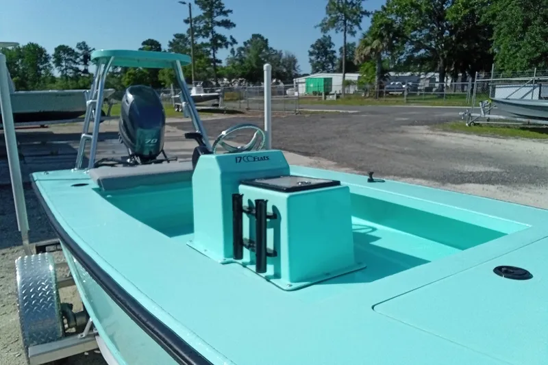 Slide: The Image of 2025 Cast & Blast 17CC Flats boat in turquoise, parked on a trailer outdoors. - 7