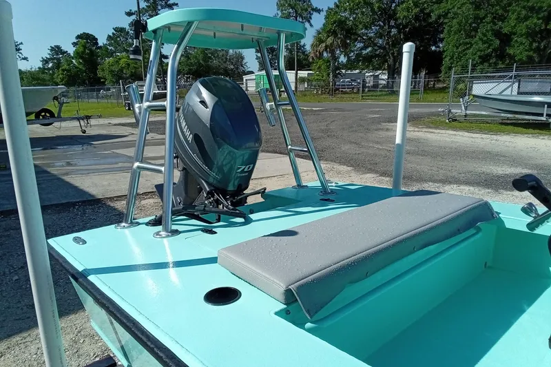 Slide: The Image of 2025 Cast & Blast 17CC Flats boat with Yamaha 70 engine, teal deck, and seating. - 8