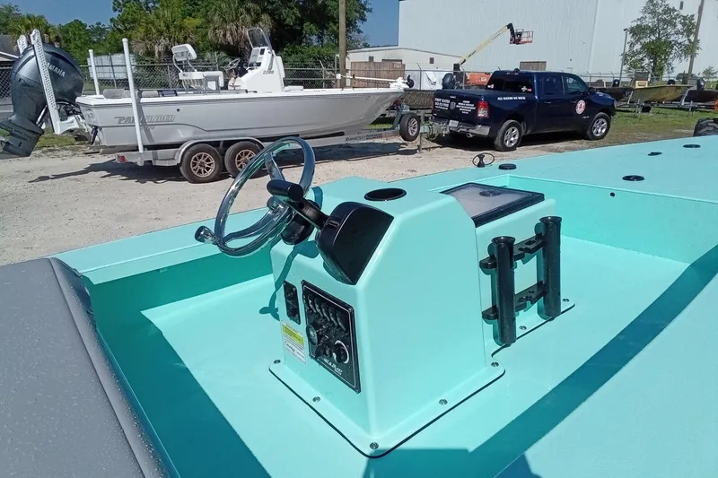 Slide: The Image of 2025 Cast & Blast 17CC Flats boat with steering console, parked outdoors. - 9