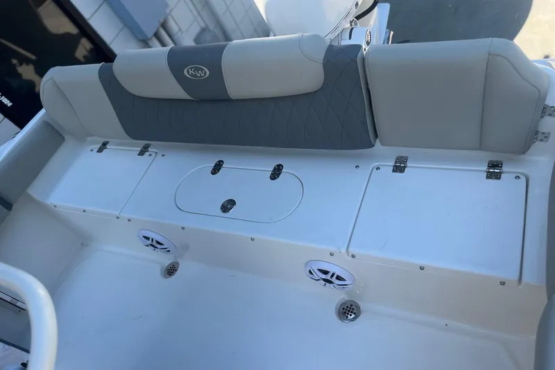 Slide: The Image of 2026 Key West 219 FS boat interior with cushioned seating and storage compartments. - 12