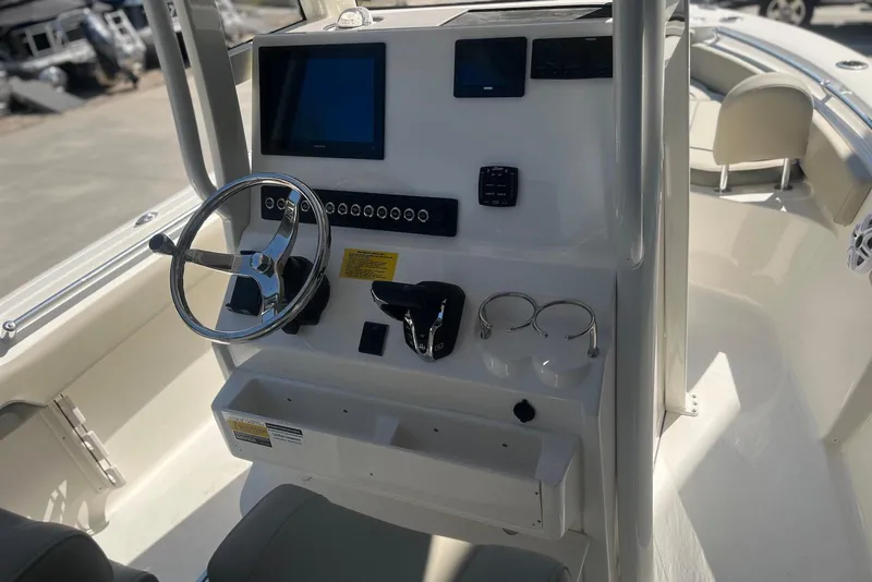 Slide: The Image of 2026 Key West 219 FS boat console with steering wheel and electronic controls. - 15