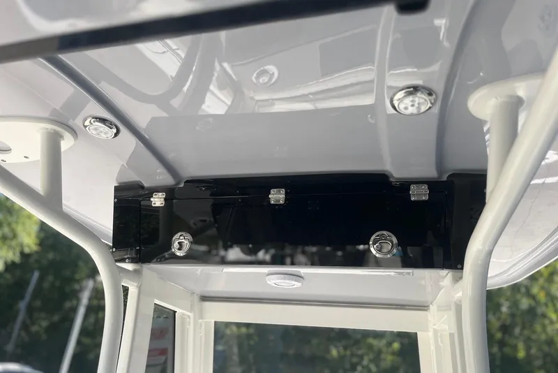Slide: The Image of 2026 Key West 219 FS boat interior, featuring sleek overhead storage and lighting. - 16
