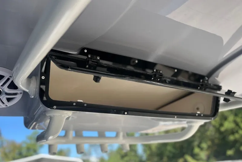 Slide: The Image of 2026 Key West 219 FS boat storage compartment with open hatch, showcasing interior details. - 19