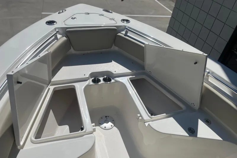 Slide: The Image of 2026 Key West 219 FS boat interior with open storage compartments and cup holders. - 29
