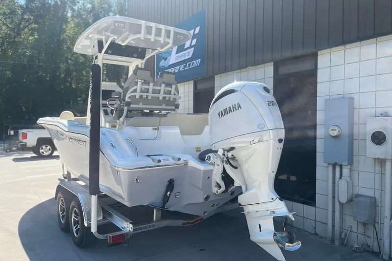 Slide: The Image of 2026 Key West 219 FS boat with Yamaha engine on trailer outside a building. - 4
